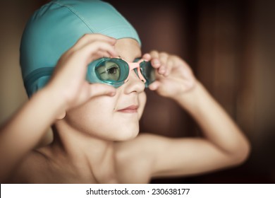 5 Years Old Child With Cap And Goggles Ready To Swim