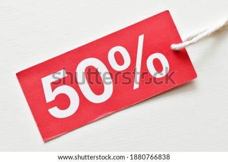 50% discount on red tag and white background. Concept in business - time for discounts and promotions.