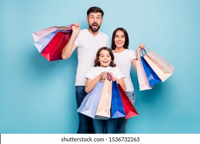 50% Off! Real Bargain Concept. Portrait Of Excited Three People Mom Dad Schoolkid Shop Center Hold Bags Scream Wow Omg Wear White T-shirt Denim Jeans Isolated Over Blue Color Background