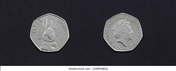 A  50 Pence Coin Minted In 2016 With The Image Of A Peter Rabbit On Front And Portrait Of Queen Elizabeth II On Reverse Isolated On Black Background.  