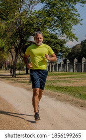 50 Year Old Man Jogging In The Park On A Beautiful Sunny Day