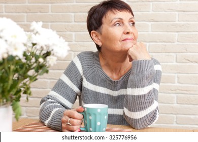 50 Years Old Attractive Woman With A Cup Of Tea At Home