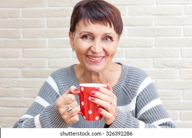 50 Years Old Attractive Woman With A Cup Of Tea At Home