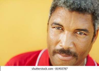 50 years old latin american man looking at camera with intense stare. Head and shoulders, copy space