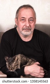 50 Years Old Man Holds A Cat