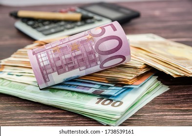 500 euro banknote rolled into a roll on the background of money and a calculator. Business concept. - Shutterstock ID 1738539161