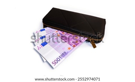 500 Euros  money currency notes inside a black purse isolated on a white background
