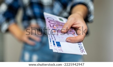 500 hundred euros banknotes in female hand.