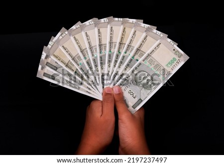 500 Indian currency in hand on black background, Indian bank notes.