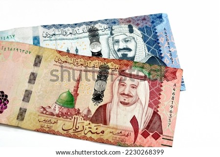 500 SAR Five hundred Saudi Arabia riyals cash money with king AbdulAziz Al Saud and Kabaa and 100 SAR one hundred Saudi Arabia riyals banknote with king Salman and Prophet mosque in Medina isolated
