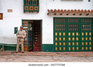 500 Year Old Town. Colombian Man Standing,door. Internet Café, Situated In Traditional Old Green And Gold Building. Plaza De Bolívar, Tunja, Boyaca, Colombia, Colombian Andes, South America 07 07 2013