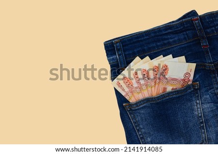 5000 russian rubles, money banknotes in the pocket of jeans, concept of salary, savings, pocket money, investments, income.