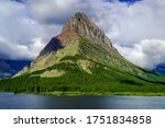 5044 Grinnell Point stands against a backdrop of clouds at Glacier National Park