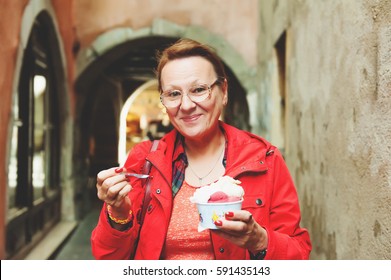 50-60 Year Old Woman Eating Ice Cream Outdoors