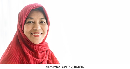 50-60 years old senior woman muslim smile isolated on white background.Portrait of old muslim woman wearing hijab at home looking at camera.Closeup face of cheerful muslim woman.indonesian.mother day.