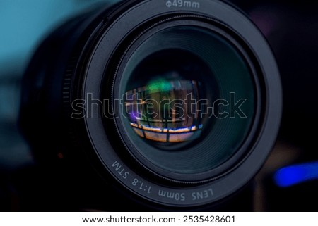50mm camera lens,Top view of a professional optical lens for modern DSLR cameras isolated on a black background. High resolution image.