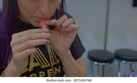 5.11.2021 Letnany, Prague, CZ The Process Of Inhaling Terpenes From A Glass Test Tube At A Medicinal Plant Show.