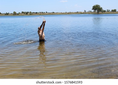 52 Year Old Man Jumping Into The Water With A Pet Bottle On The Sailors Island In Southern Brazil Making Beautiful Movements With The Water