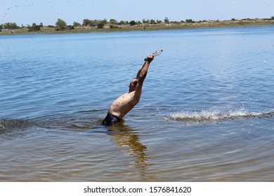 52 Year Old Man Jumping Into The Water With A Pet Bottle On The Sailors Island In Southern Brazil Making Beautiful Movements With The Water