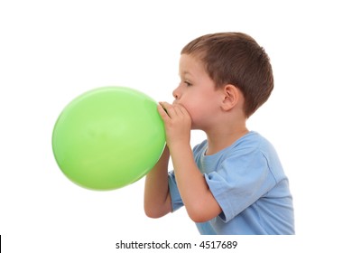 5-6 years old boy blowing up balloon isolated on white