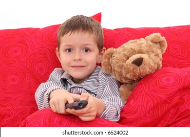 5-6 Years Old Boy Watching TV In Bed