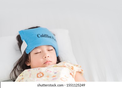 5.7 Years Old Girl.Patient Kid Girl Sleep On The Bed In Hospital.She Have Gel Pack Or Cold Pack On Her Head For Decrease High Fever Temperature.Concept For Fever, Medical And Treatment In Hospital.