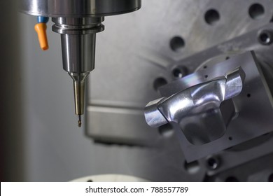 The 5-axis CNC Machine Cutting The Sample Part.The Aero Spaces Part Manufacturing Process By 5-axis CNC Machine.Modern Manufacturing Process.