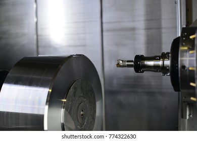 The 5-axis CNC machine while cutting the sample part of turbine.The spindle of 5 axis CNC machining center white cutting turbine sample part.