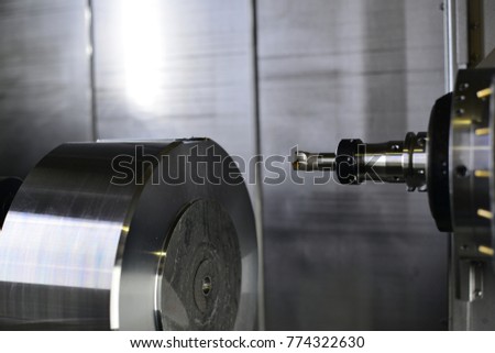 The 5-axis CNC machine while cutting the sample part of turbine.The spindle of 5 axis CNC machining center white cutting turbine sample part.