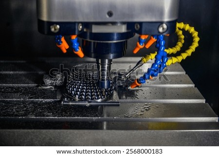 The 5-axis CNC milling machine cutting the automotive part with solid ball end mill tool.