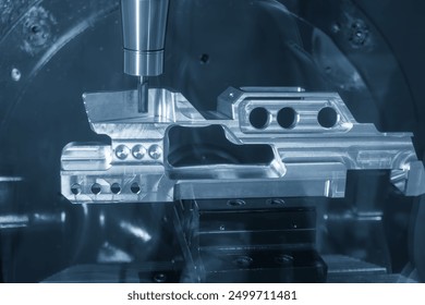 The 5-axis machining center cutting aerospace parts with solid ball nose end mill tool in the light blue scene. The hi-precision automotive manufacturing process by multi-axis CNC milling machine. - Powered by Shutterstock