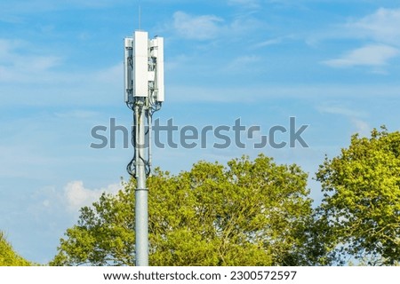 5G antenna on a telecommunication mast with a blue sky
