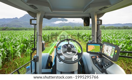 5G autonomous tractor working in corn field, Future technology with smart agriculture farming concept