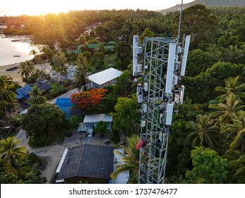 5G Cell Phone Mast In A Populated Urban Area. 5G Tower Next To Houses In A Town, Village Or City.