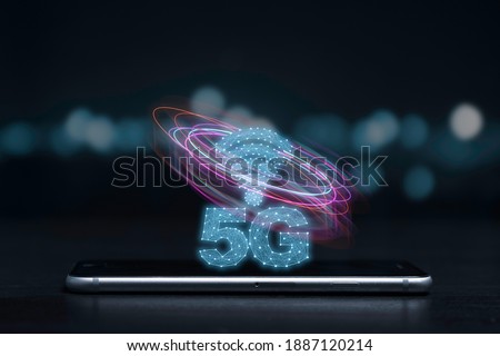 5G and internet of things or IOT concept, 5G and internet sign with virtual effect on smartphone. IOT is high technology which every device will connect and control by 5G high speed internet.