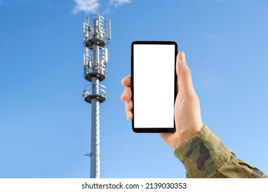 5G Military Communication Tower With Man Using Mobile Smart Phone