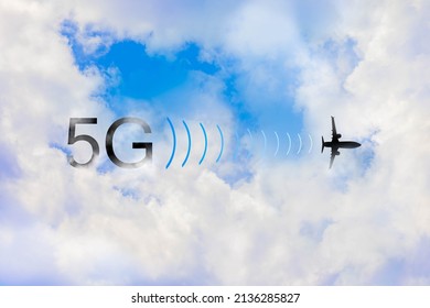 5G Signal Interference With Plane Altimeter. Silhouette Of Flying Airplane With Text Floating Over White Clouds Blue Sky. Concept Of Aviation Concerned Of High Speed Internet Connection While Landing.