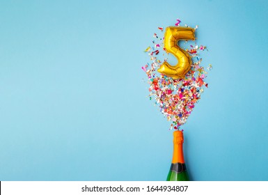 5th anniversary champagne bottle balloon pop - Shutterstock ID 1644934807