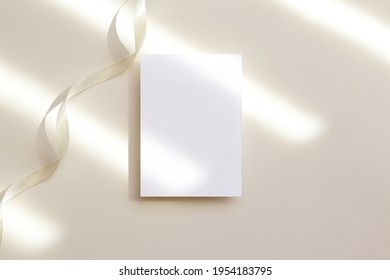 5x7 White Photo Frame Mockup With Ribbon On Beige Background