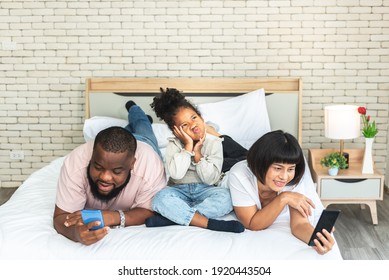 A 5-year-old African-American Girl, Showing Up In A Bad Mood Because Her Parents Are Not Interested, And Using Mobile Phones All The Time, To Family And Social Media Concept.