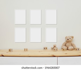 6 Blank Vertical Frames Mockup On Wall For Nursery Wall Art Display, Baby Room Six White Frames Mock Up, Wooden Shelf, Soft Toys And Wooden Toys On Shelf.