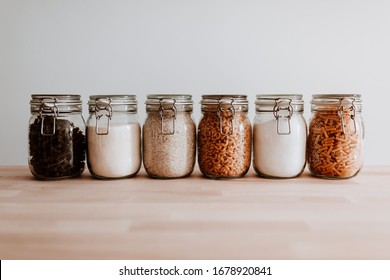 6 glass jars with pasta rice and flour