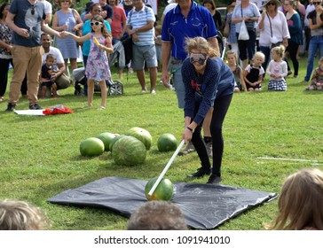 6 May 2018 Blindfolded girl smashing watermelon with stick. Botanic Garden Australia, Coffs Harbour. Traditional Japanese game Suikawari or Watermelon Splitting - Japanese Festival of Children's Day