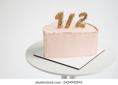 6 month birthday cake isolated on white background. Bento pink cake with decor for a six month old baby. Creative way to celebrate party. Anniversary decor in the form of decimal meaning half of year. - Powered by Shutterstock