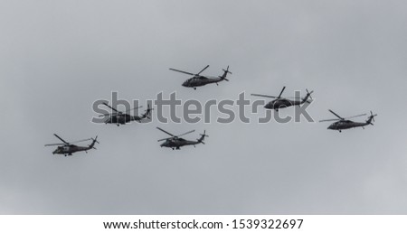 6 war helicopters flying in strategy formation