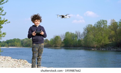 6 Year Old Boy Flies With Drone In Nature Near A River - New Technology About Video 4k And Photography 