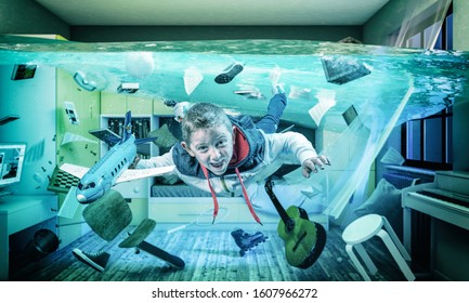 6 year old caucasian child plays happy with an airplane in his flooded room. Surreal image, concept of light-heartedness.