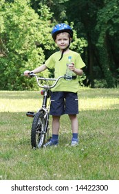 6 Years Old Boy With Bike And Bottle Of Water