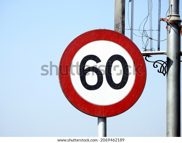 60\
KM Speed limit sign a highway, sixty kilometers per hour traffic\
road sign, a restriction sign for car drivers not to exceed the\
speed over 60 kilometers per hour                  \
