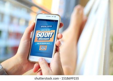 60% OFF Sale. Woman in a hammock with a smartphone with a 60% discount advertising on the screen.  Marketing, ecommerce, discount, email marketing, cell phone publicity. - Shutterstock ID 1518699155